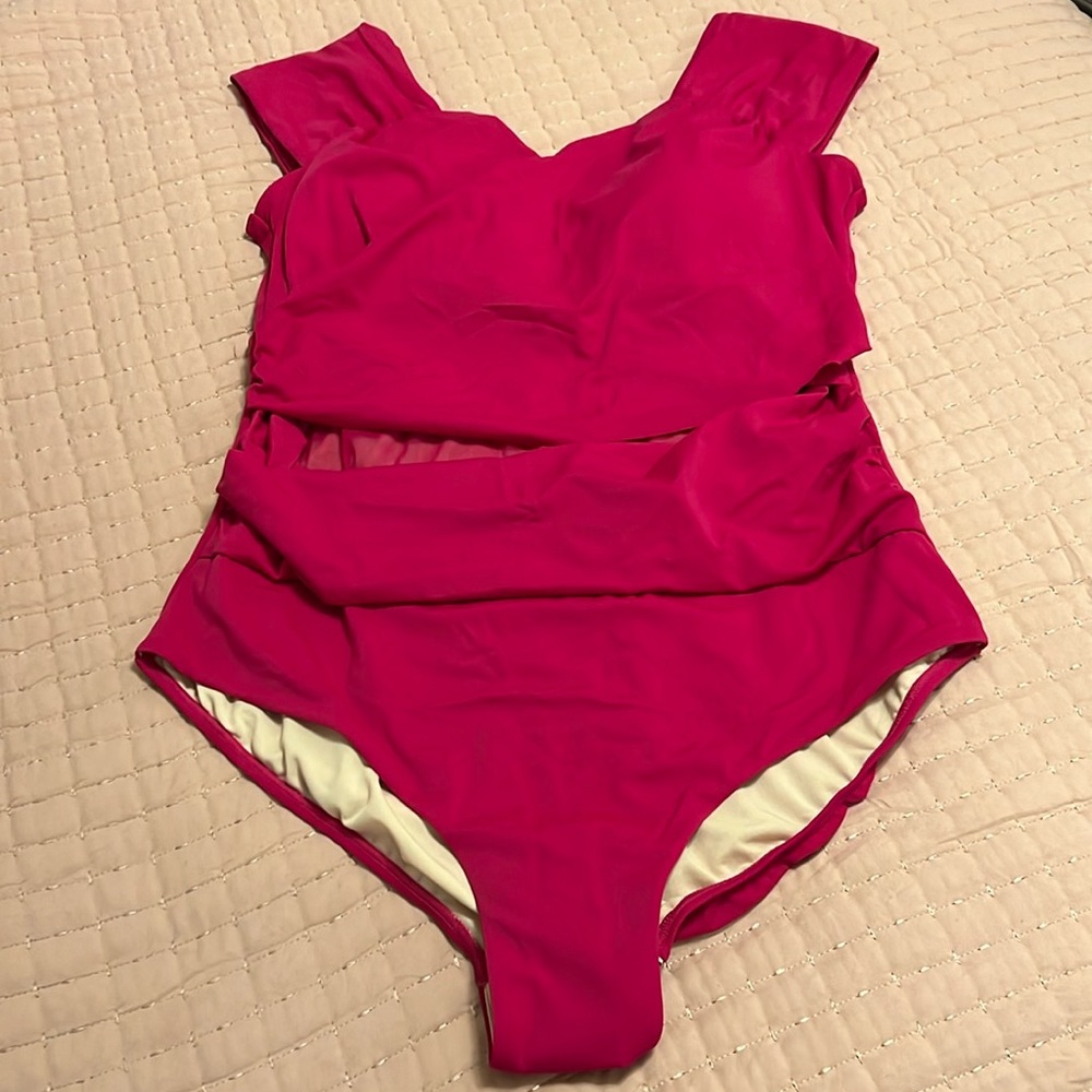 Cap sleeve cut swimsuit with mesh mid section; no wires, padded bra